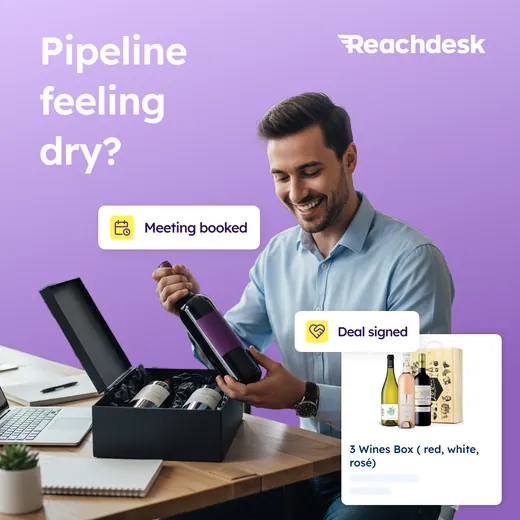 Reachdesk ad showing a man lifting a bottle out of a black wine gift box at his desk with floating Meeting booked and Deal signed labels, headlined Pipeline feeling dry?