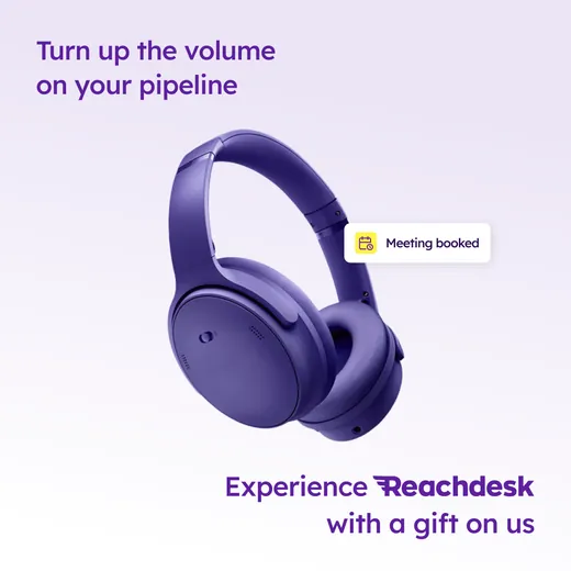 Reachdesk ad showing large purple over-ear headphones on a pale lilac background with a Meeting booked calendar notification beside them, headlined Turn up the volume on your pipeline